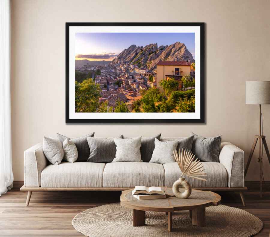 Large framed fine art print of Pietrapertosa Italy displayed in the living room of a modern home