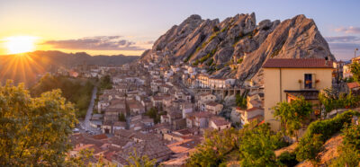Small mountain town of Pietrapertosa at sunset with a soft warm light from the sun on the town and mountains