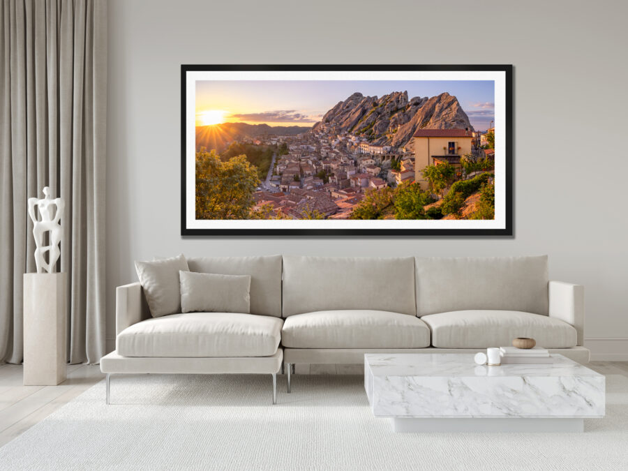 Large framed image of the small mountian town of Pietrapertosa in Italy displayed above the couch in the living room of a moder luxury home