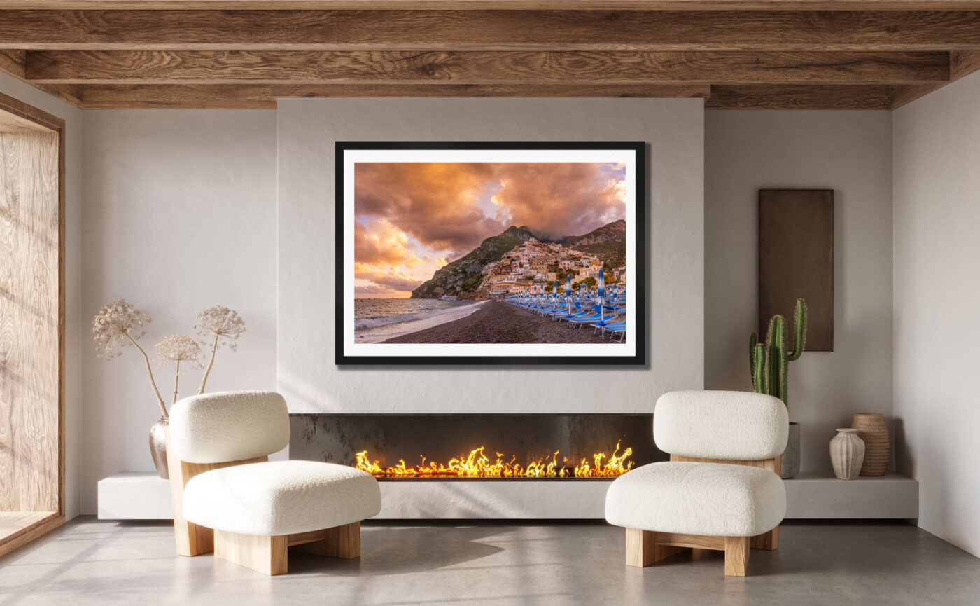 Large fraimied print of Positano Italy on the Amalfi Coast displayed in the living room of a luxury home