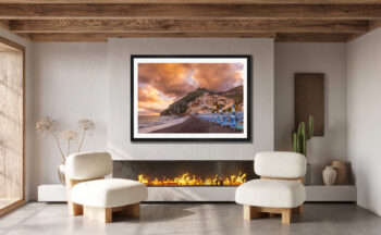 Large fraimied print of Positano Italy on the Amalfi Coast displayed in the living room of a luxury home