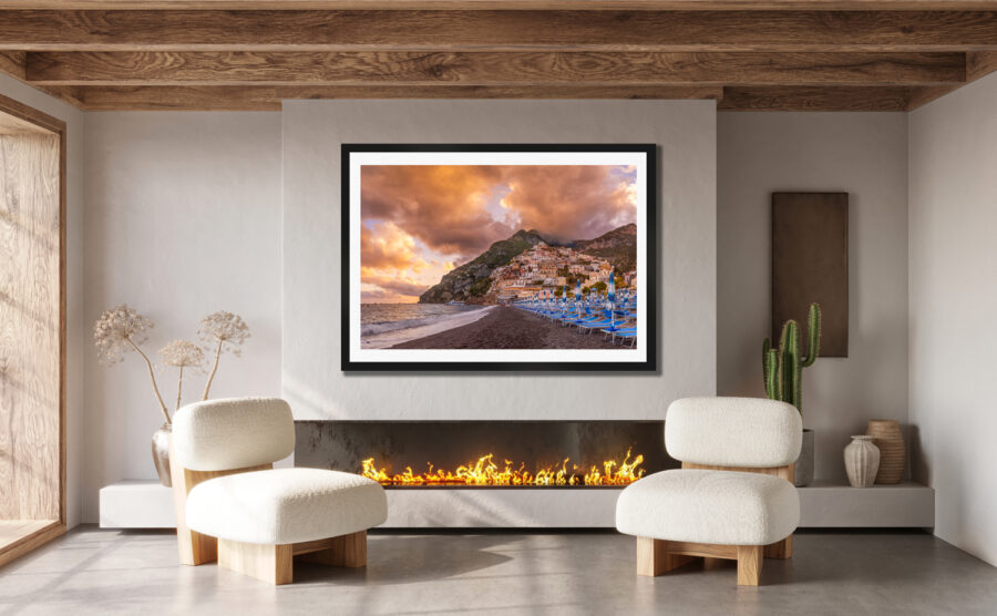 Large fraimied print of Positano Italy on the Amalfi Coast displayed in the living room of a luxury home