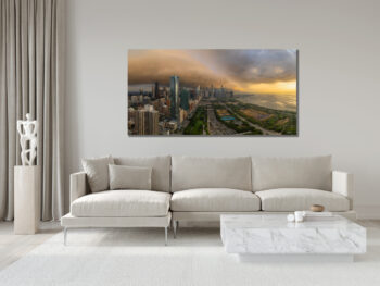 Large unframed panoramic fine art print of chicago with a storm over it at sunrise displayed in the living room of a modern house