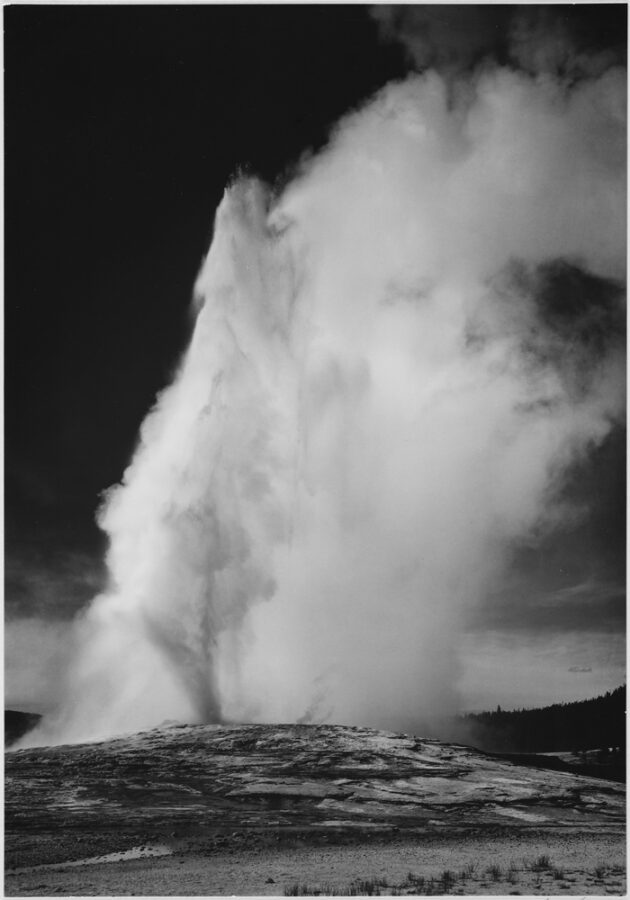 black and white photograph from famous landscape photographer Ansel Adams of Old Faithful in Yellowstone National Park