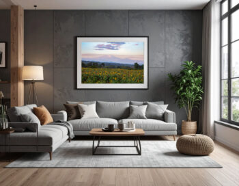 Large framed fine art print of mount kilimanjaro displayed above the couch of a modern home