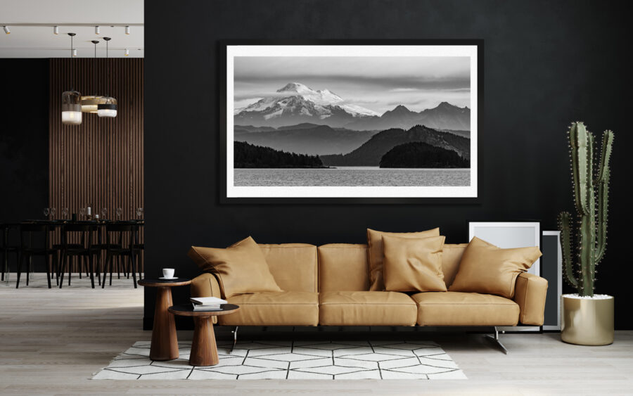 Large framed fine art photographic print of moutains in Washington State displayed in the living room of a luxury home