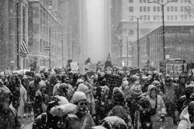 photograph of protesters marching in Chicago during a snowstorm
