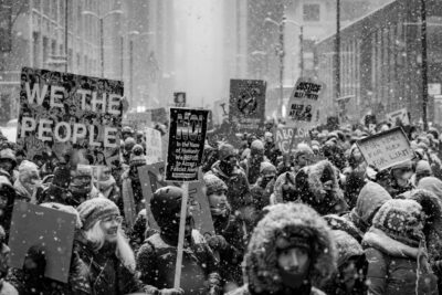 fine art photograph of Americans protesting in the streets of Chicago in the snow.