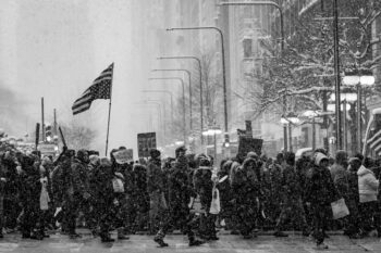 fine art photograph of Chicago residents protesting in the streets covered in snow.