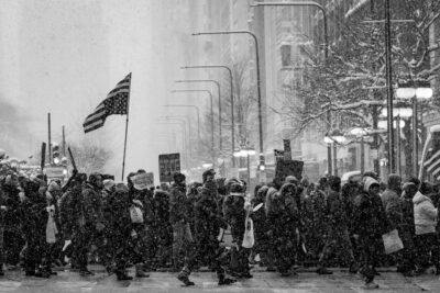 fine art photograph of Chicago residents protesting in the streets covered in snow.