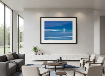 large fine art photograph of a lone lighthouse on a deep blue Lake Michigan during winter displayed in a modern home.