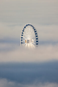 Photograph of Chicago's Ferris Wheel sticking out above the fog on Navy Pier