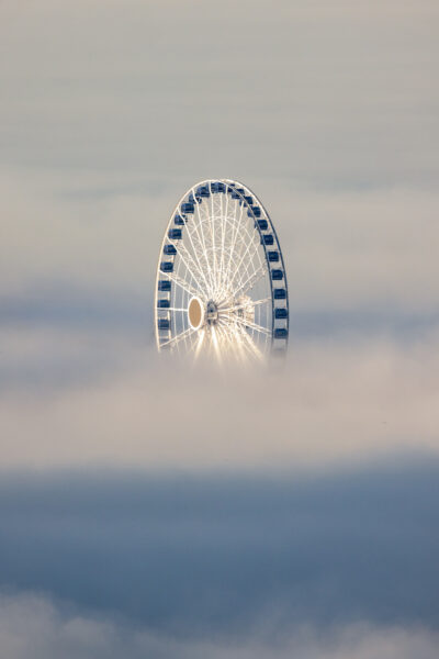Photograph of Chicago's Ferris Wheel sticking out above the fog on Navy Pier