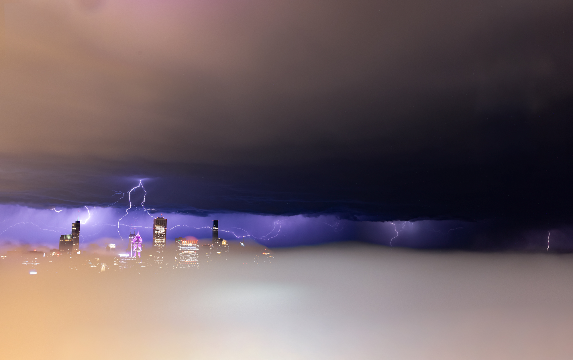 Chicago Storm photo with the lightning above the fog
