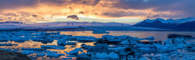 large fine art panoramic photograph of a glacial lagoon in Iceland as sunset