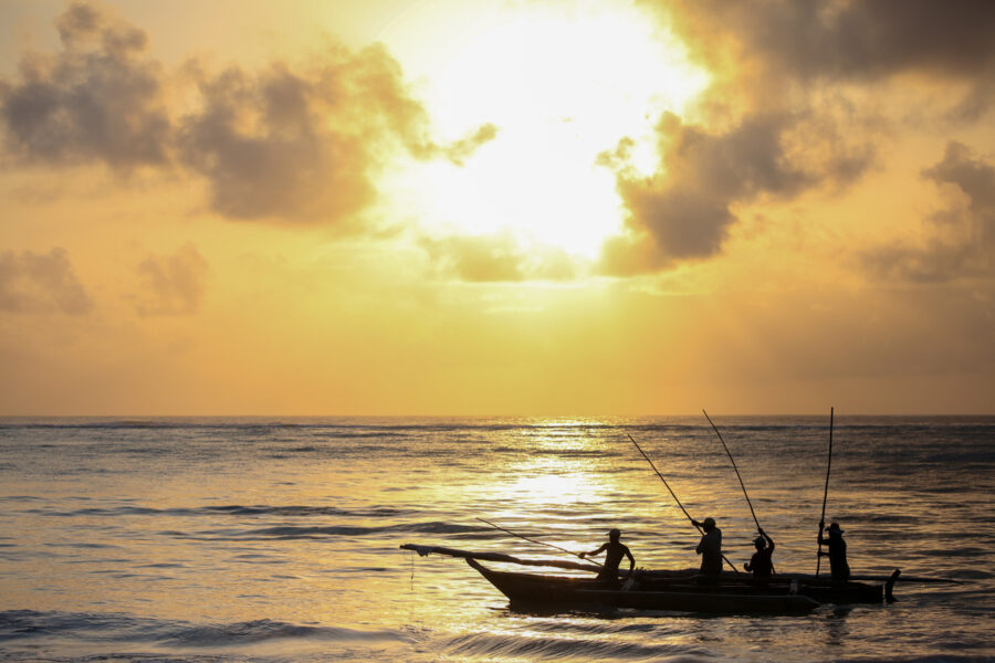 fisherman heading out in the morning for a day of fishing on the ocean off Zanzibar